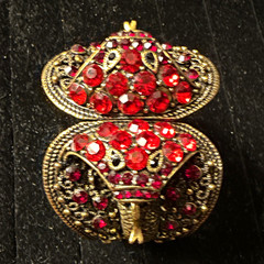 vintage gold-tone bracelet filigree adorned red ruby-colored glass rhinestones.