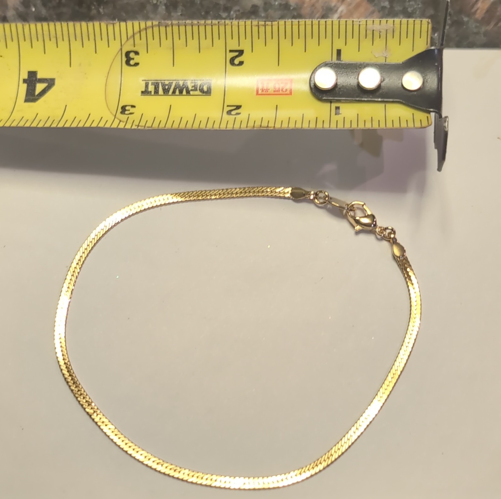 This is a gold Tone herringbone snake chain bracelet and necklace send Style gallery