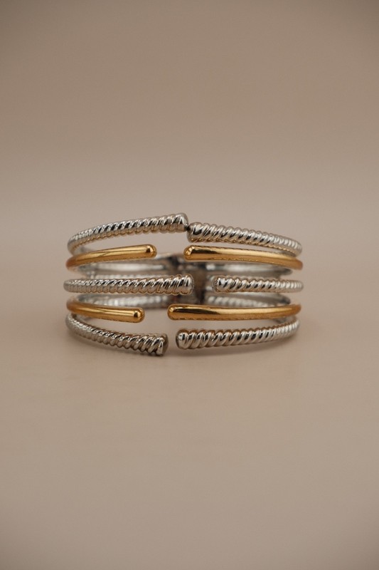 Chic two tone cuff bracelet with cross over design. gallery