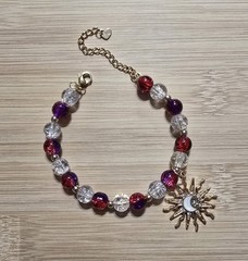 Red, Clear, Gold Bead Bracelet with a Sun Charm