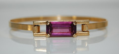 ELEGANT AVON COUTURE PURPLE STONE ON GOLDEN METAL STATEMENT HINGED CUFF BRACELET