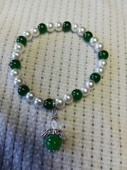 This 5″ Bracelet Features An Angel With An 8mm Green Glass Bead In Silvertone.