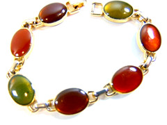 gold tone modern bracelet with multi-colored oval jewels; signed LC