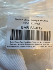 BaubleBar White Drawstring Pouch in Clear Packaging