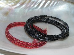 Gently Used Lot of 2 Black Various Shaped Plastic & Glass & Red Bead Wrap Brace
