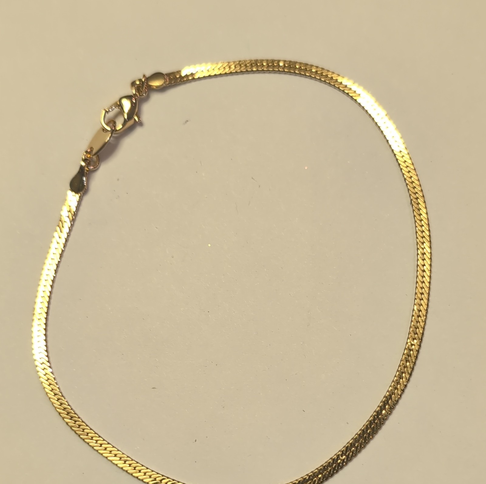This is a gold Tone herringbone snake chain bracelet and necklace send Style gallery