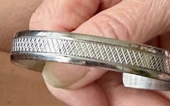 Silver-tone cuff bracelet with a central textured geometric band