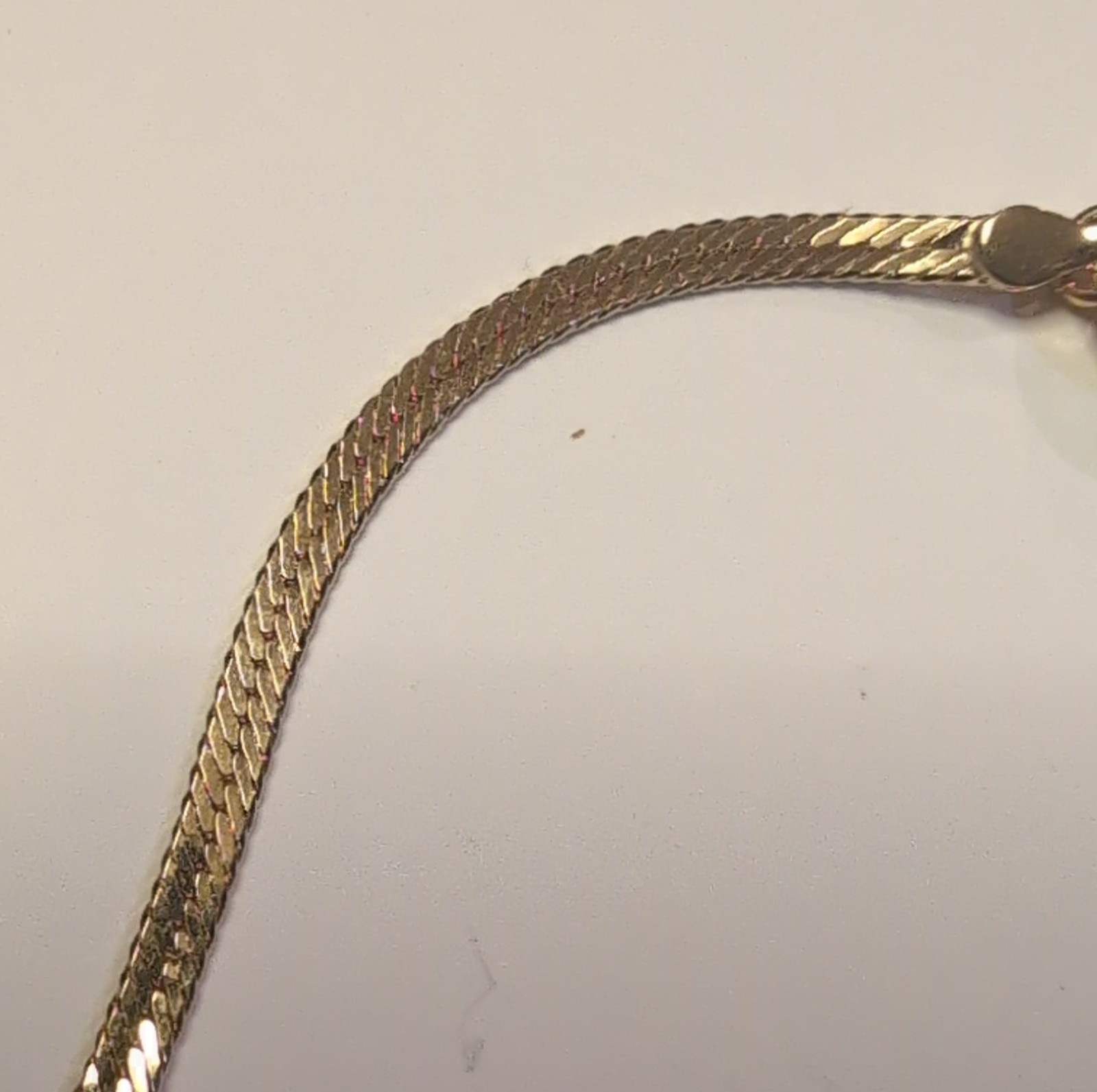 This is a gold Tone herringbone snake chain bracelet and necklace send Style gallery