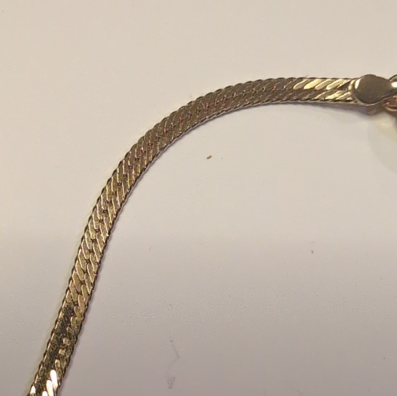 This is a gold Tone herringbone snake chain bracelet and necklace send Style gallery