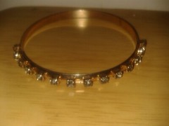Mid 2000’s gold tone, 14 diamante’s bangle bracelet. 6.5cm (D21c4)