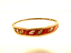 silver color cuff bracelet accented with shell inset in red enamel